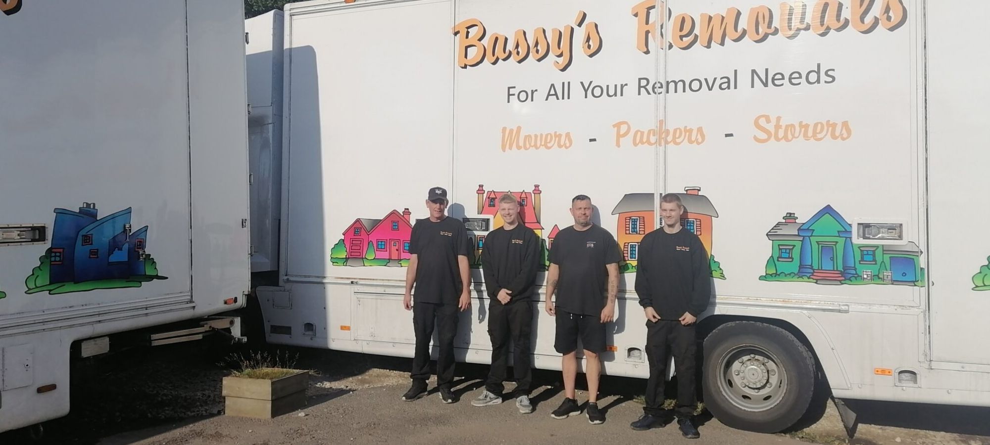 The Bassy's Removals team in front of their branded removals lorry